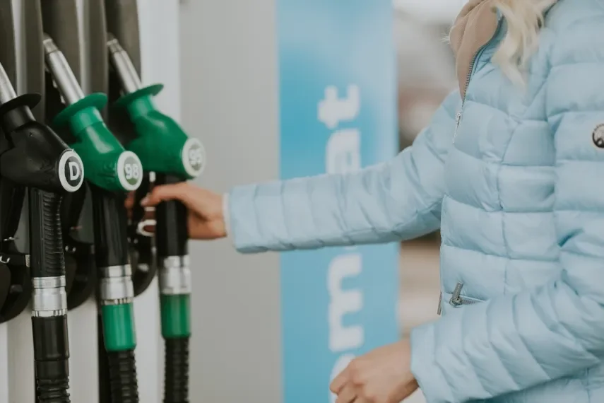 Woman using the fuel tanker at a fuel station